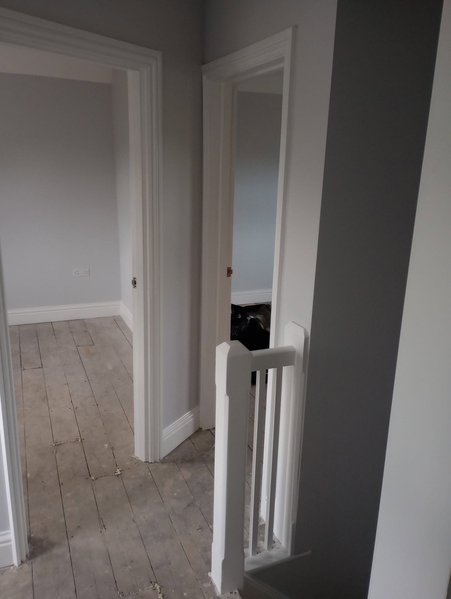 Landing with grey walls and white doors and frames