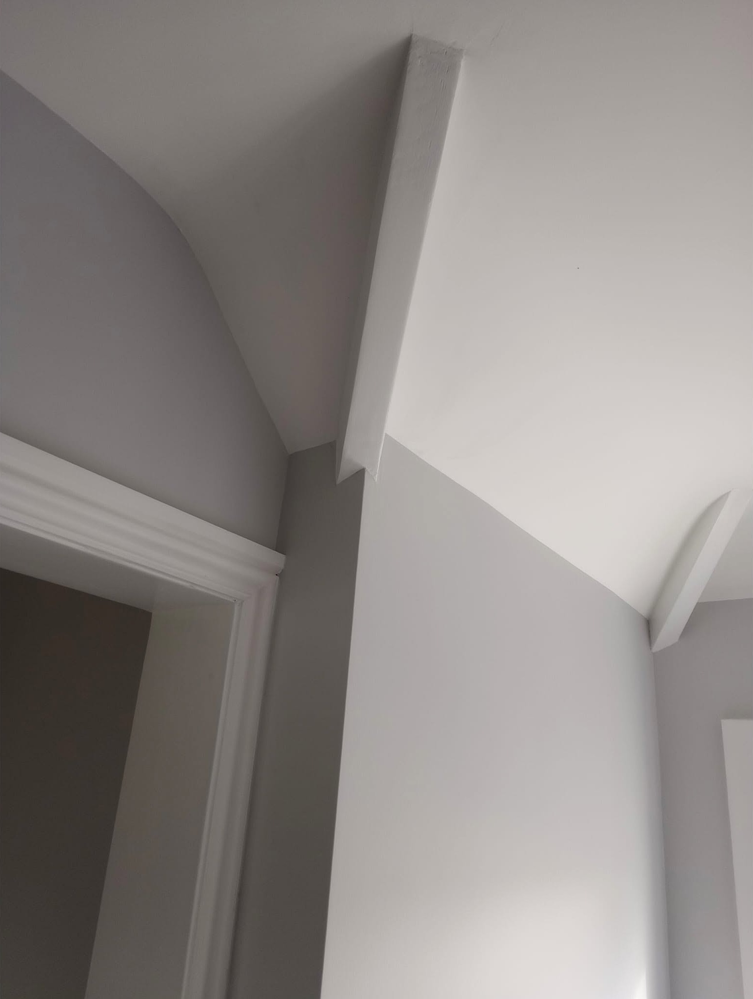 Landing ceiling angles with crisp lines between grey walls and white woodwork