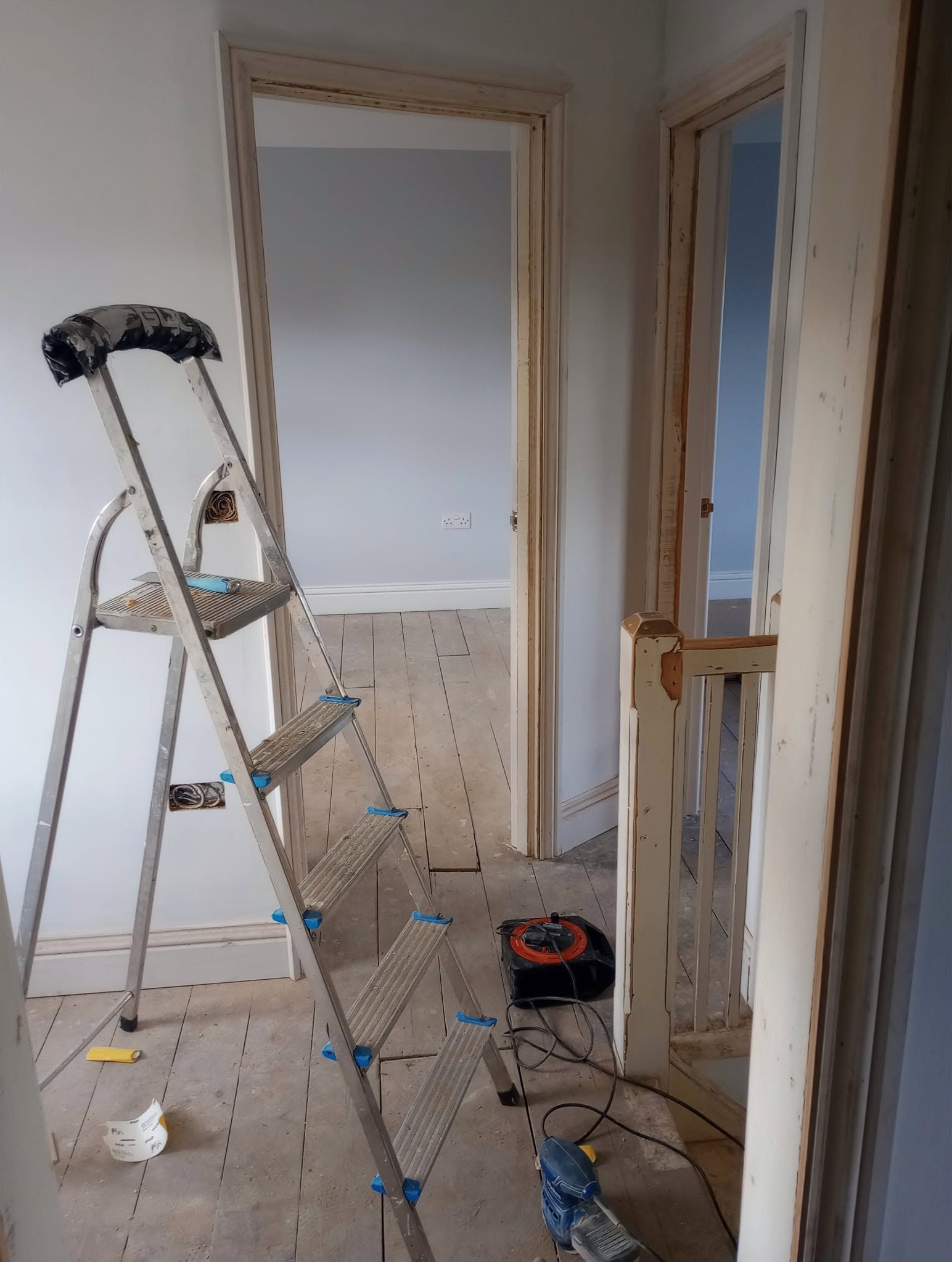Landing mid-job with a stepladder and freshly prepared walls