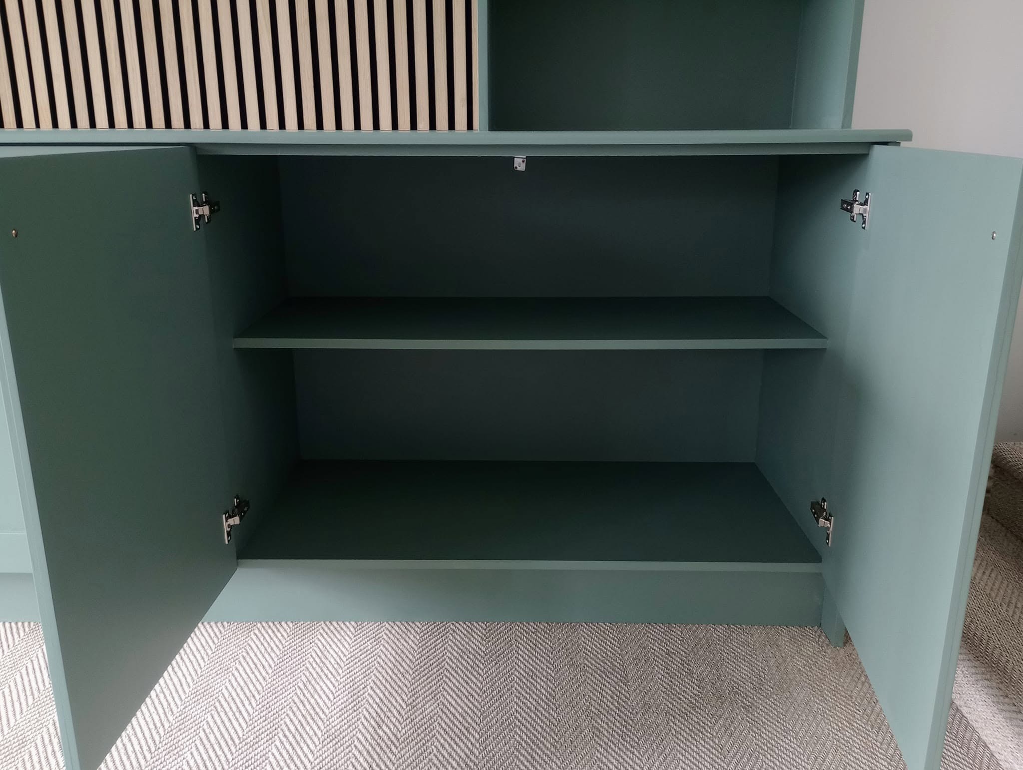 Inside one of the media unit cupboards, painted in the same green