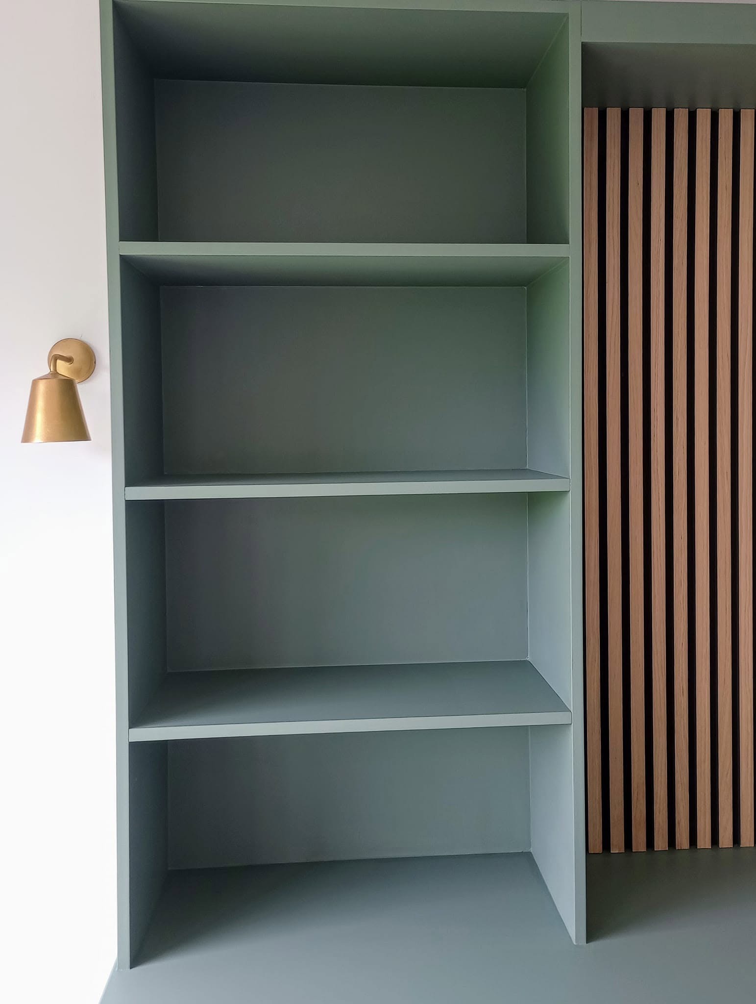Open shelves beside the slatted panel