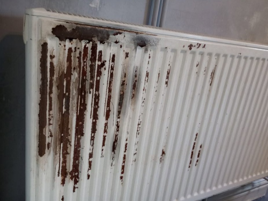 White radiator streaked with rust before painting