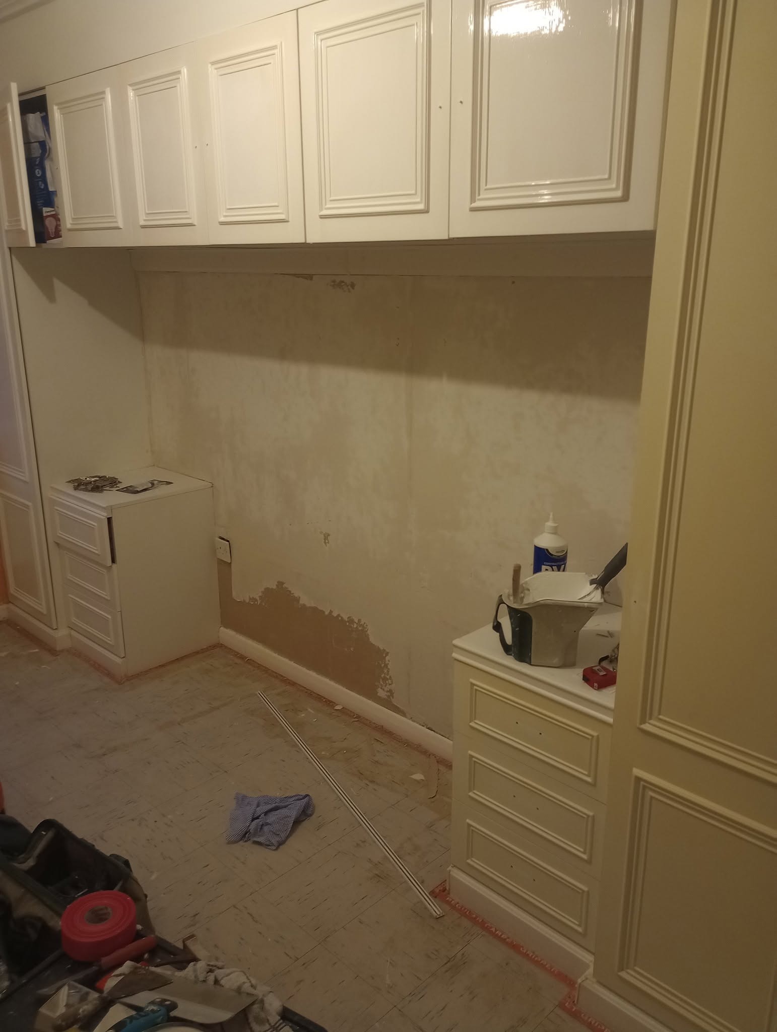Built-in wardrobes with the wall stripped, ready for work